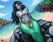 A mermaid lounges on a rock by the sea.