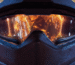 A Helldiver from Helldivers 2 seeing the ruination of Super Earth in the visor of their helmet.