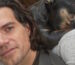 Henry Cavill sharing couch space with his dog after busting up his leg on Highlander