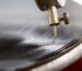 A closeup shot of a needle of the gramophone with a shellac disk.